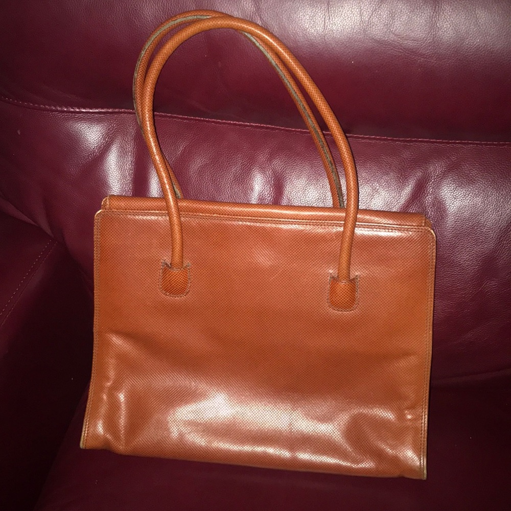 Rust/brown/orange leather bag.